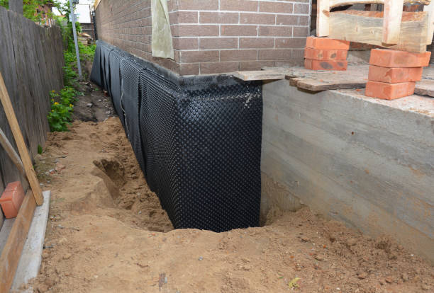 SJ Waterproofing Pros technician performing targeted Wet Basement Repair assessment in Gates Mills, OH